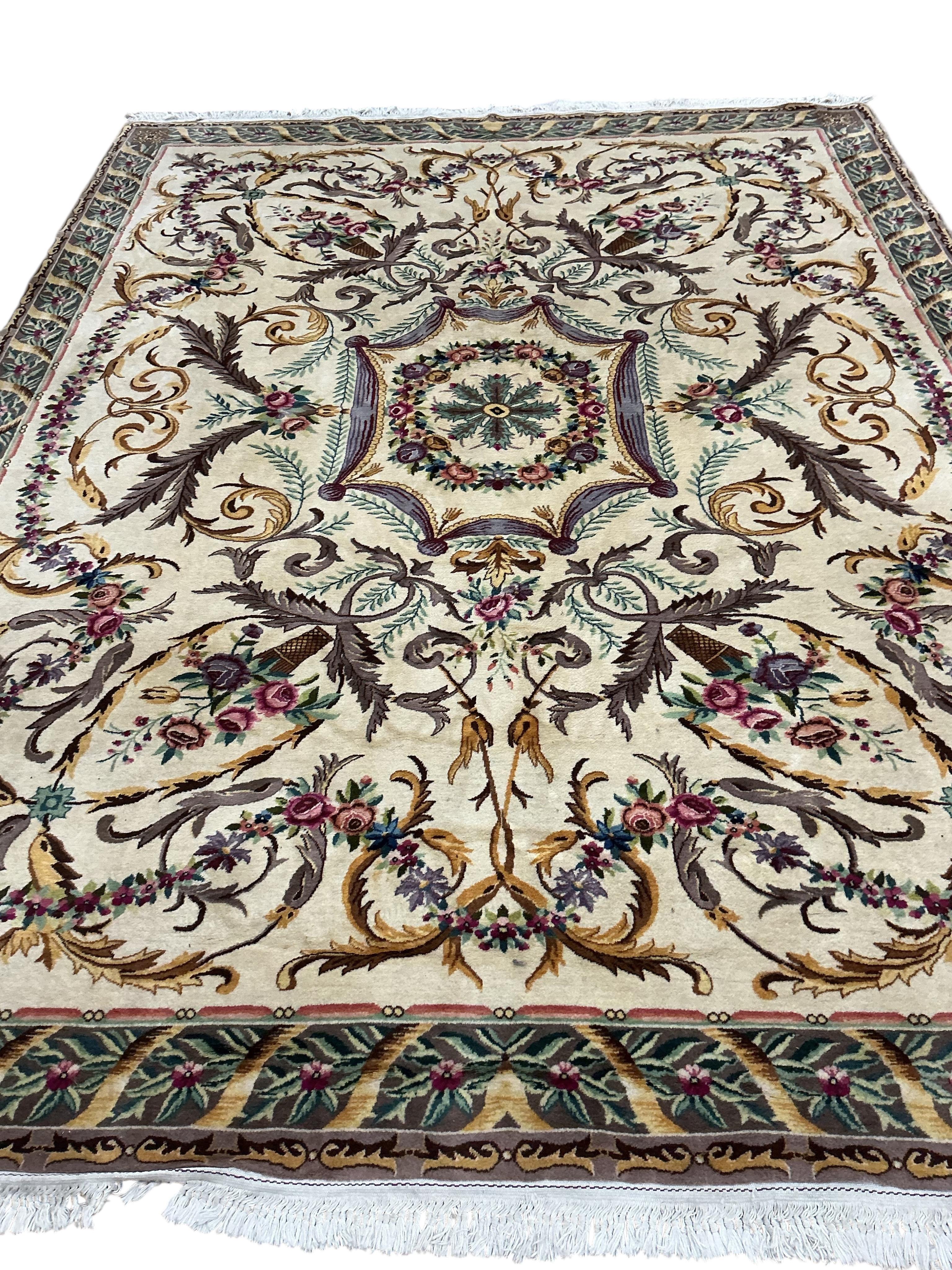 An Aubusson style ivory ground carpet, 325 x 245cm